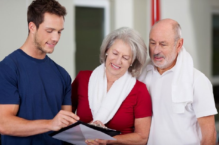 Physical Fitness Trainer with Senior Couple